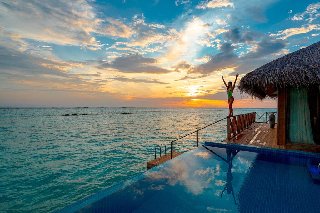 Guest enjoying a luxury oceanfront Airbnb at sunset, illustrating how memorable experiences create stronger Airbnb positioning and guest appeal.