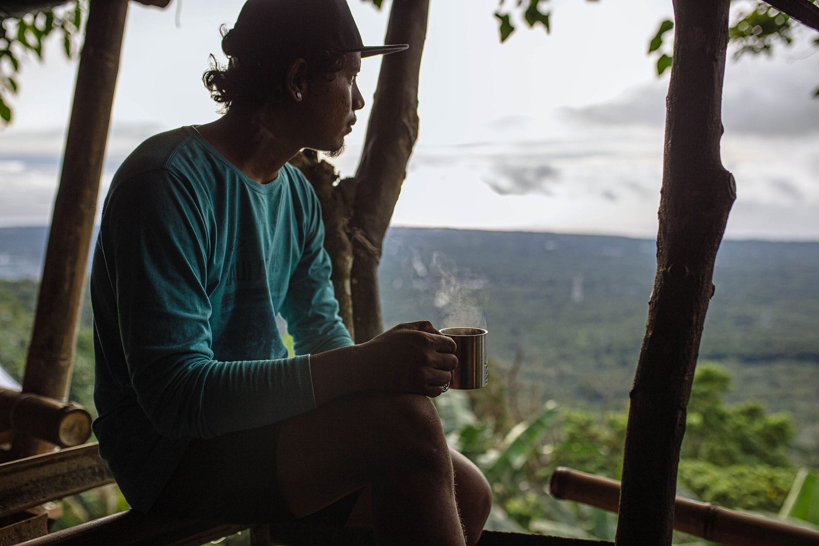 Guest enjoying a quiet morning coffee surrounded by nature at a vacation rental