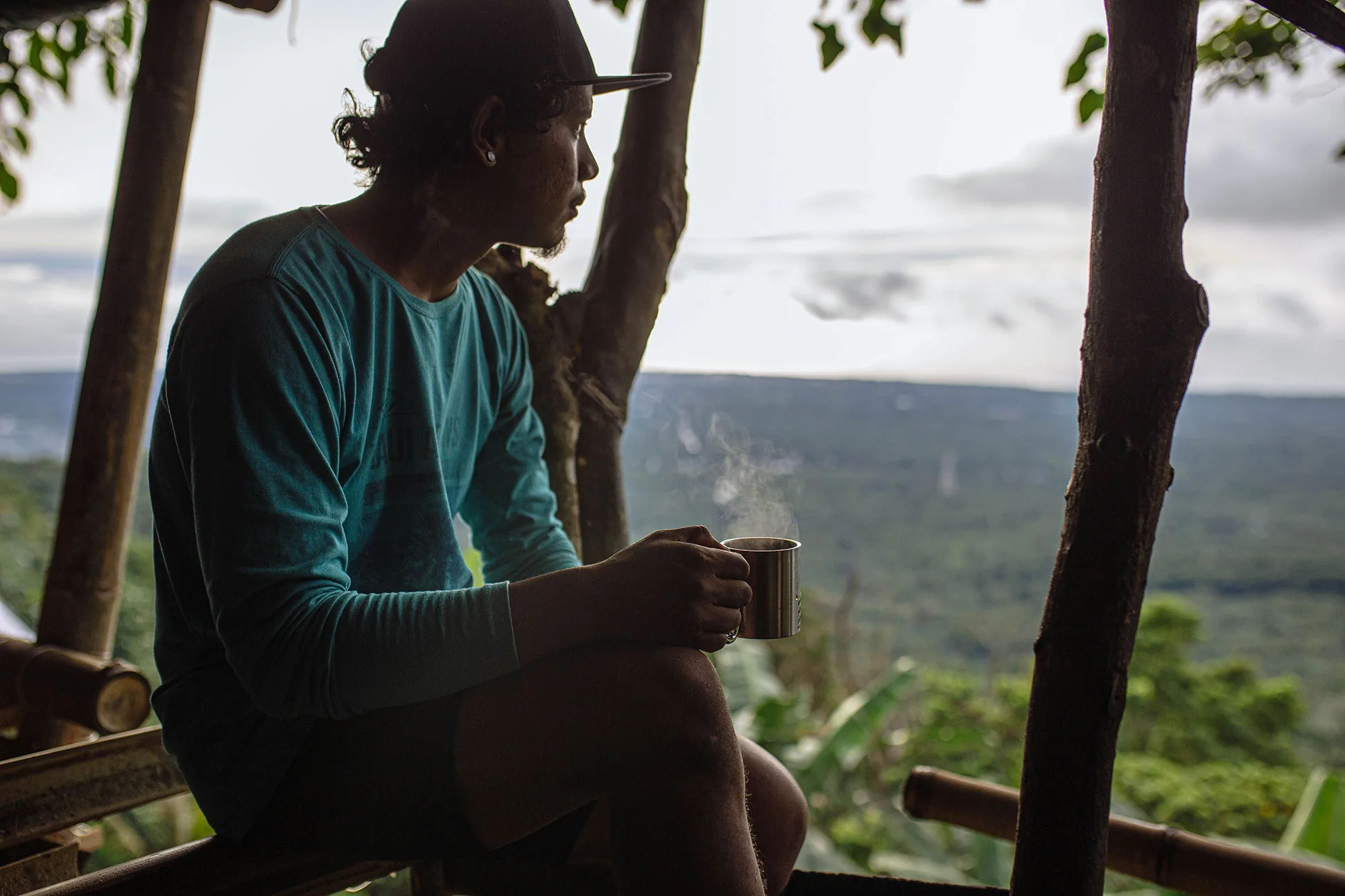 Guest enjoying a quiet morning coffee surrounded by nature at a vacation rental