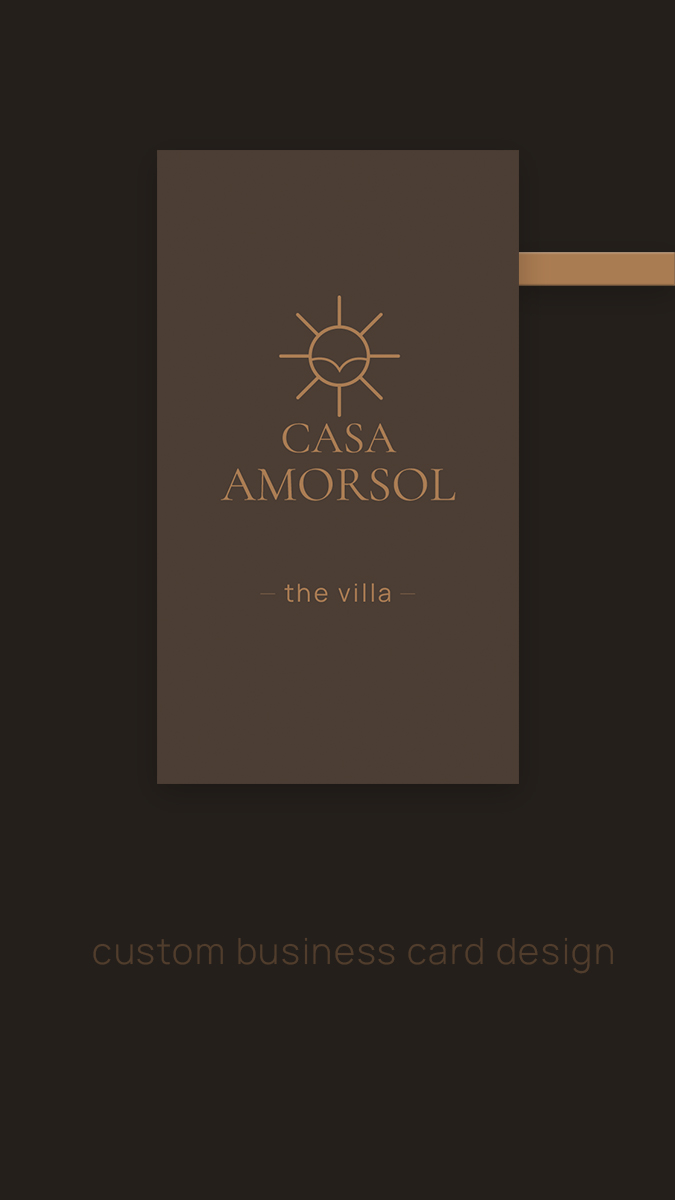 Elegant Casa Amorsol business card design with a minimal bronze sun logo, refined serif branding, and a deep warm-brown background. The front side highlights the villa’s identity with a clean, upscale, modern aesthetic.