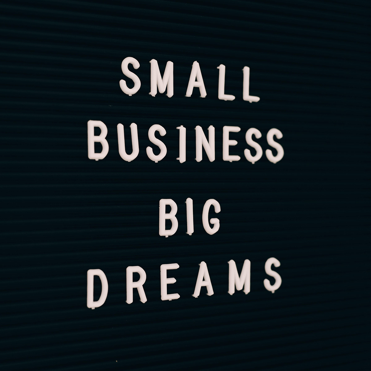 Black letter board with the words “Small Business Big Dreams” in white capital letters.