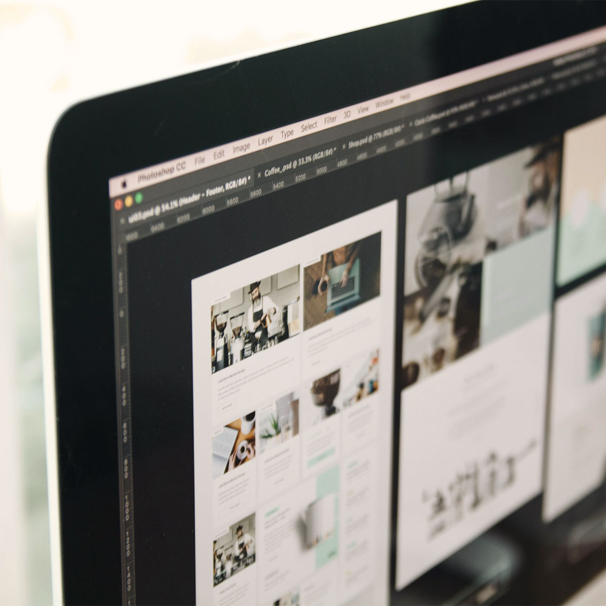 Computer screen showing website mockups in design software, representing Visible PR’s web design process.
