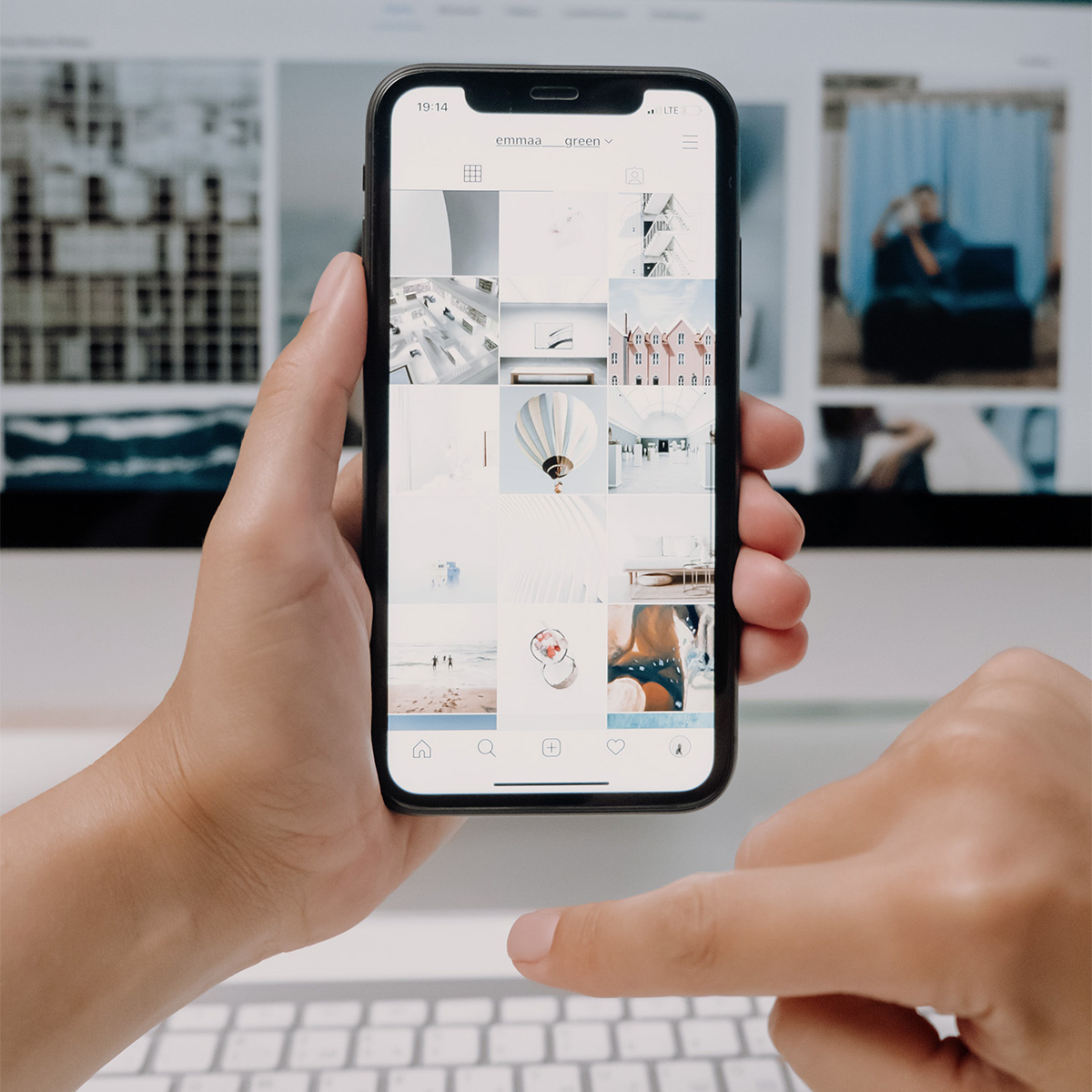 Hand holding smartphone with visual content displayed, symbolizing Visible PR’s results on mobile and social media.