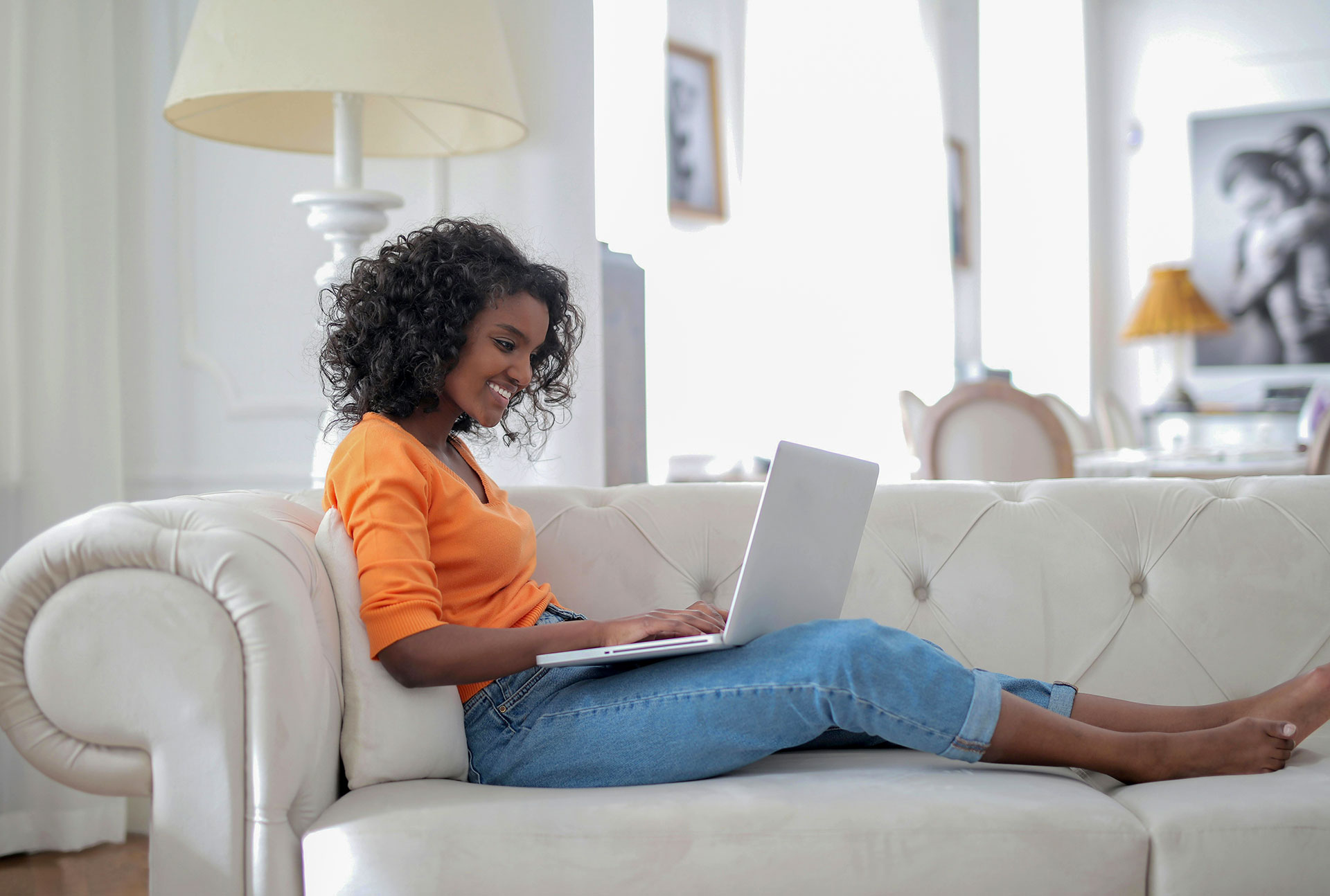 Woman planning a vacation rental stay on her laptop in warm natural light, illustrating how most Airbnb bookings are made by women.